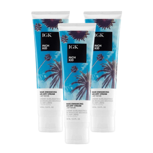 Three tubes of IGK Rich Kid wave enhancing air-dry cream standing upright.