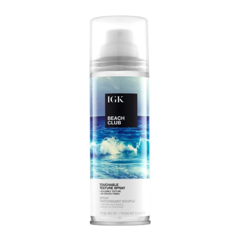 A can of IGK Beach Club Touchable Texture Spray with ocean-themed packaging.