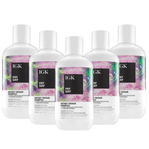Five bottles of IGK Pay Day Instant Repair Shampoo arranged in a row.